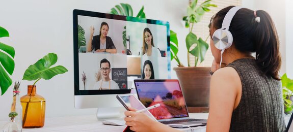 Asian business woman work from home with laptop, tablet and computer on table with meeting online and video conferencing.Concept of social distancing to stop the spread disease of Corona virus. 