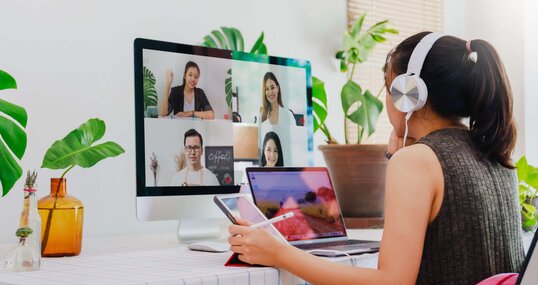 Asian business woman work from home with laptop, tablet and computer on table with meeting online and video conferencing.Concept of social distancing to stop the spread disease of Corona virus. 