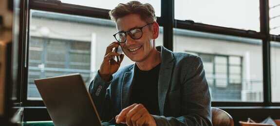 Corporate professional sitting making a phone call