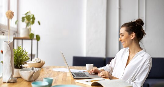 Creative young woman working on laptop in her studio