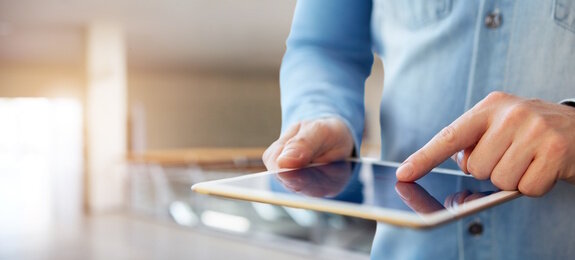 Male hand touching a digital tablet