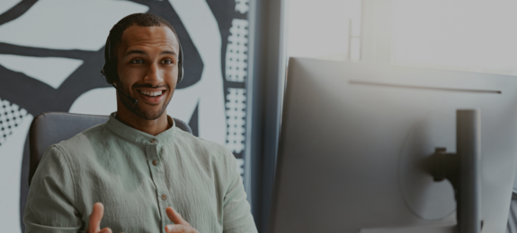 Handsome african businessman working computer while sitting in modern coworking