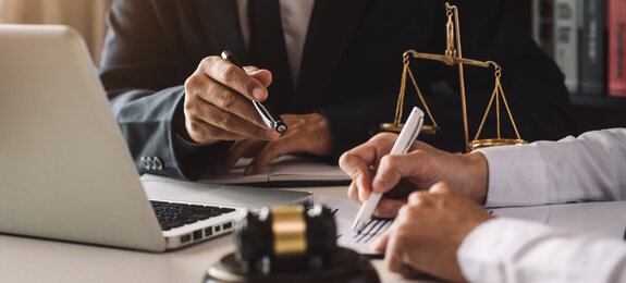 business people and lawyers discussing contract papers sitting at the table. Concepts of law, advice, legal services. in morning light