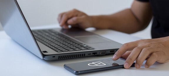 Cyber security concept. Business people type passwords and press the check button on a mobile smartphone application connect to the database via a data security system technology on display at office