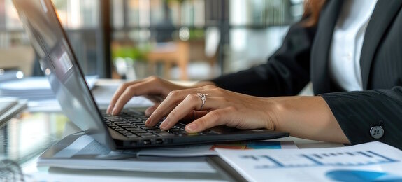 business woman close up of a person typing on a laptop computer