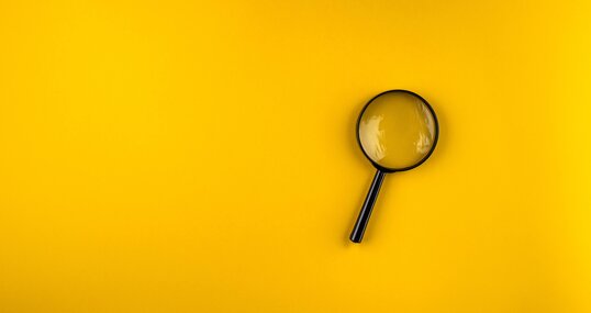 magnifying glass on yellow background
