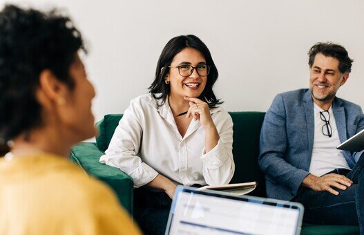 Diverse business people having a meeting with their colleague in an office