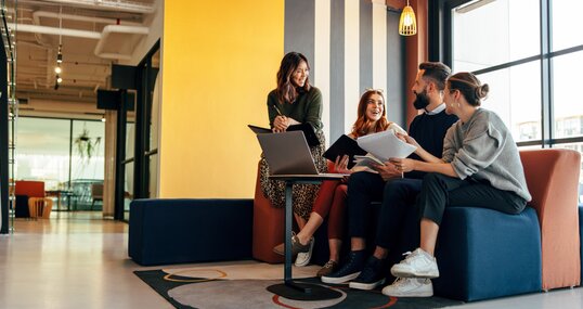 Multicultural businesspeople working in an office lobby