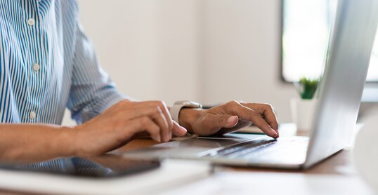 Close up hands of businesswoman typing on laptop keyboard to working and searching business data