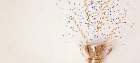 Trophy and confetti on light background, top view with space for text. Victory concept