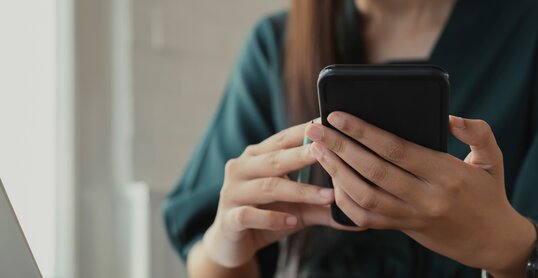 Close up of woman using mobile phone.