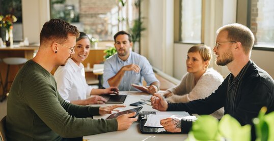 Businessman sharing new business plan with team